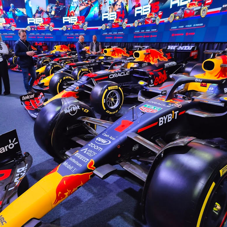 Red Bull race cars in front of screens